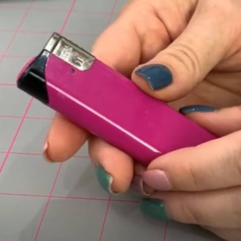 Cigarette lighter that is purple in colour.